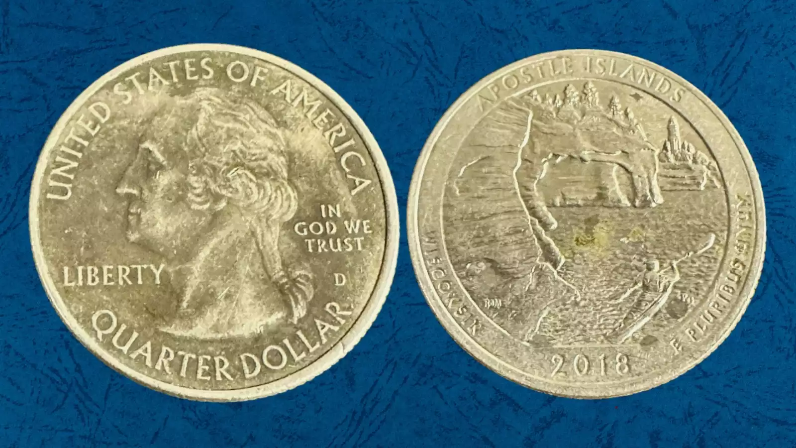 Side-by-side comparison of a normal 2018 quarter with standard silver clad surface (left) versus a 2018 quarter with missing clad layer showing exposed copper core (right)