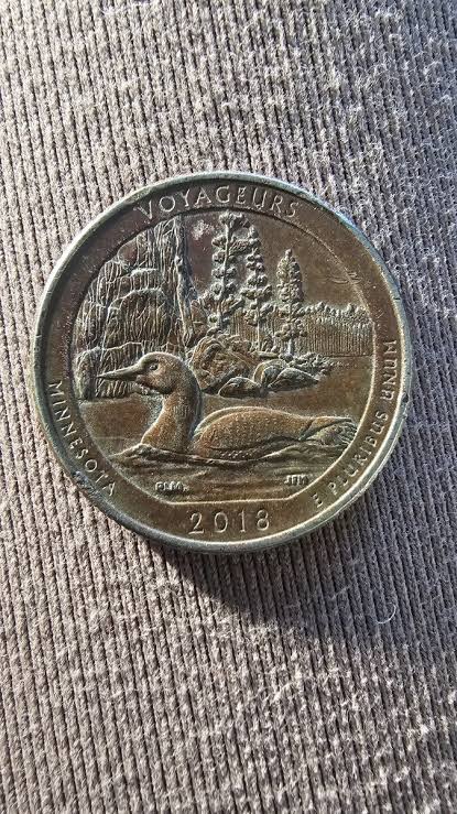 2018 quarter missing clad layer error showing exposed copper core where cupronickel cladding is absent